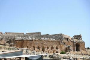 ANTALYA, TURKEY - MAY 15, 2021 Ruins of ancient city Hierapolis near Pamukkale, Turkey at sunny day. Parts of old historical buildings with big blocks photo