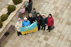 TERNOPIL, UKRAINE - APRIL 2, 2023 People with flag during mission in complex of Ukrainian Jerusalem in the Mari spiritual center of Zarvanytsia In the Terebovlya district of the Ternopil photo
