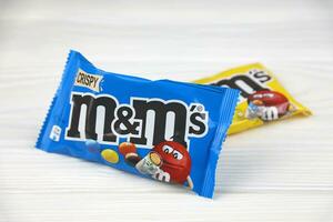 KHARKIV, UKRAINE - JANUARY 2, 2021 M and Ms colorful button shaped chocolate candies. Multi colored chocolates each of which has the letter m printed in lower case in white photo