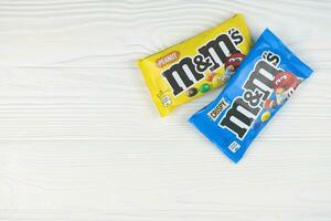 KHARKIV, UKRAINE - JANUARY 2, 2021 M and Ms colorful button shaped chocolate candies. Multi colored chocolates each of which has the letter m printed in lower case in white photo