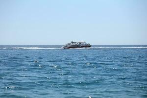 ANTALYA, TURKEY - MAY 15, 2021 Luxurious inflatable rib speed boat cruising in mediterranean deep sea photo