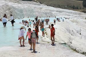 ANTALYA, TURKEY - MAY 15, 2021 Turquoise pools in travertine terraces at Pamukkale. Cotton castle in southwestern Turkey photo