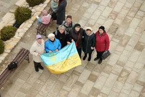 TERNOPIL, UKRAINE - APRIL 2, 2023 People with flag during mission in complex of Ukrainian Jerusalem in the Mari spiritual center of Zarvanytsia In the Terebovlya district of the Ternopil photo