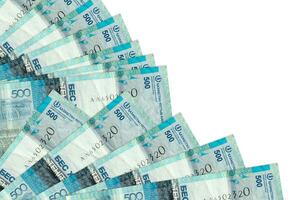 500 Kazakhstani tenge bills lies isolated on white background with copy space stacked in fan close up photo