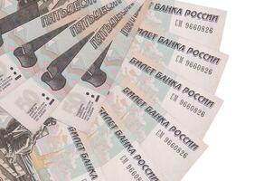 50 russian rubles bills lies isolated on white background with copy space stacked in fan shape close up photo