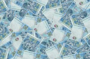 5 Ukrainian hryvnias bills lies in big pile. Rich life conceptual background photo