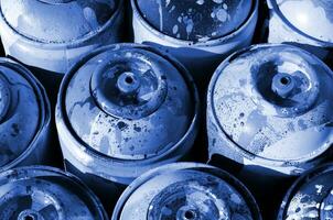 A lot of used phantom classic blue color metal tanks with paint for drawing graffiti photo