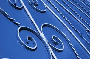 Metal texture of a piece of phantom classic blue wall with a forged pattern photo