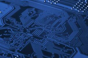 Close up of colored micro circuit board. Abstract technology background. phantom classic blue color photo