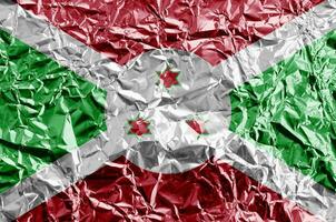 Burundi flag depicted in paint colors on shiny crumpled aluminium foil closeup. Textured banner on rough background photo