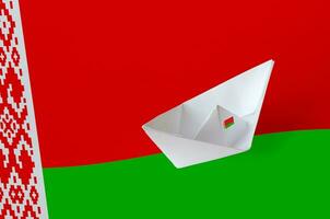 Belarus flag depicted on paper origami ship closeup. Handmade arts concept photo