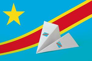 Democratic Republic of the Congo flag depicted on paper origami airplane. Handmade arts concept photo