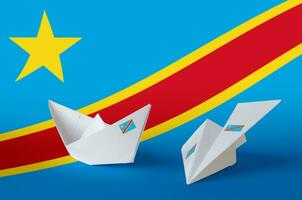 Democratic Republic of the Congo flag depicted on paper origami airplane and boat. Handmade arts concept photo