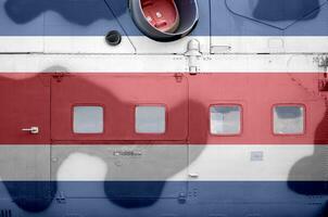 Costa Rica flag depicted on side part of military armored helicopter closeup. Army forces aircraft conceptual background photo