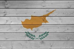 Cyprus flag depicted in bright paint colors on old wooden wall. Textured banner on rough background photo