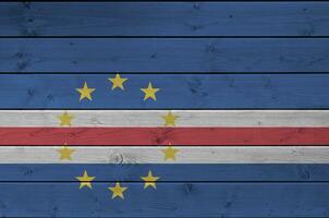 Cabo verde flag depicted in bright paint colors on old wooden wall. Textured banner on rough background photo