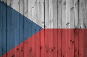 Czech flag depicted in bright paint colors on old wooden wall. Textured banner on rough background photo