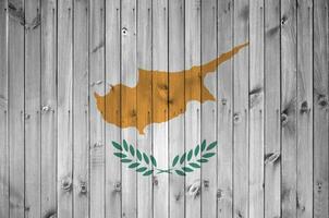 Cyprus flag depicted in bright paint colors on old wooden wall. Textured banner on rough background photo