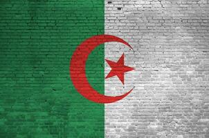 Algeria flag depicted in paint colors on old brick wall. Textured banner on big brick wall masonry background photo