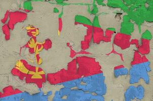 Eritrea flag depicted in paint colors on old obsolete messy concrete wall closeup. Textured banner on rough background photo