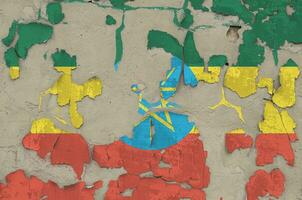 Ethiopia flag depicted in paint colors on old obsolete messy concrete wall closeup. Textured banner on rough background photo