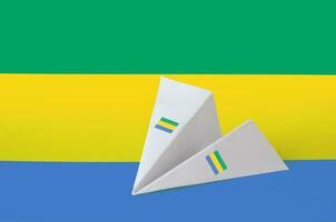 Gabon flag depicted on paper origami airplane. Handmade arts concept photo