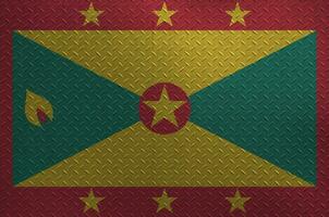 Grenada flag depicted in paint colors on old brushed metal plate or wall closeup. Textured banner on rough background photo