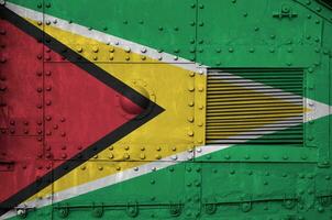 Guyana flag depicted on side part of military armored tank closeup. Army forces conceptual background photo