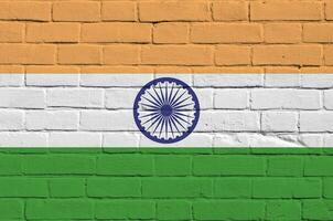 India flag depicted in paint colors on old brick wall. Textured banner on big brick wall masonry background photo