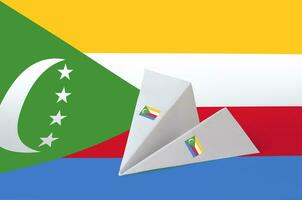 Comoros flag depicted on paper origami airplane. Handmade arts concept photo
