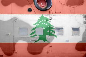 Lebanon flag depicted on side part of military armored helicopter closeup. Army forces aircraft conceptual background photo