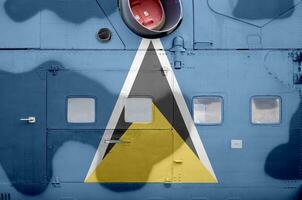 Saint Lucia flag depicted on side part of military armored helicopter closeup. Army forces aircraft conceptual background photo