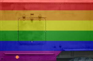 LGBT community flag depicted on side part of military armored truck closeup. Army forces conceptual background photo