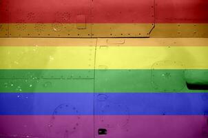 LGBT community flag depicted on side part of military armored helicopter closeup. Army forces aircraft conceptual background photo