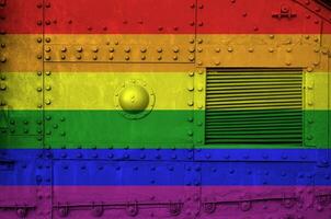 LGBT community flag depicted on side part of military armored tank closeup. Army forces conceptual background photo