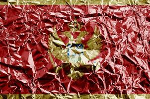 Montenegro flag depicted in paint colors on shiny crumpled aluminium foil closeup. Textured banner on rough background photo