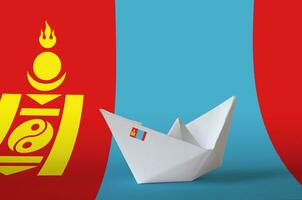 Mongolia flag depicted on paper origami ship closeup. Handmade arts concept photo