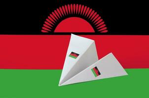 Malawi flag depicted on paper origami airplane. Handmade arts concept photo