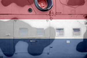 Netherlands flag depicted on side part of military armored helicopter closeup. Army forces aircraft conceptual background photo