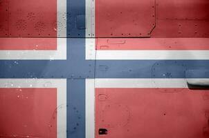 Norway flag depicted on side part of military armored helicopter closeup. Army forces aircraft conceptual background photo