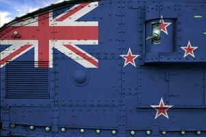New Zealand flag depicted on side part of military armored tank closeup. Army forces conceptual background photo