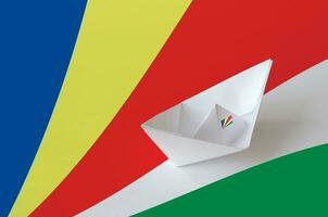 Seychelles flag depicted on paper origami ship closeup. Handmade arts concept photo