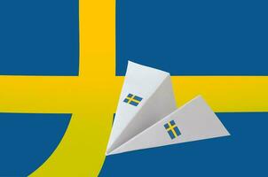 Sweden flag depicted on paper origami airplane. Handmade arts concept photo