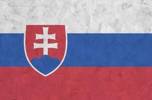 Slovakia flag depicted in bright paint colors on old relief plastering wall. Textured banner on rough background photo