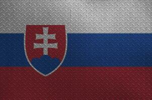 Slovakia flag depicted in paint colors on old brushed metal plate or wall closeup. Textured banner on rough background photo