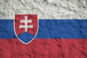 Slovakia flag depicted in bright paint colors on old relief plastering wall. Textured banner on rough background photo