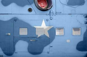 Somalia flag depicted on side part of military armored helicopter closeup. Army forces aircraft conceptual background photo