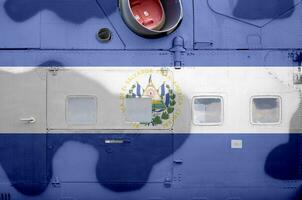 El Salvador flag depicted on side part of military armored helicopter closeup. Army forces aircraft conceptual background photo