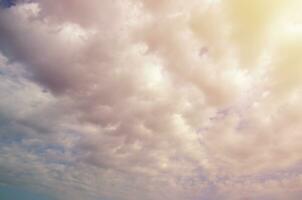 Blue sky background with white fluffy clouds in daytime outdoors photo