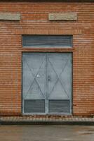 Old metallic grey door with attention high voltage sign photo